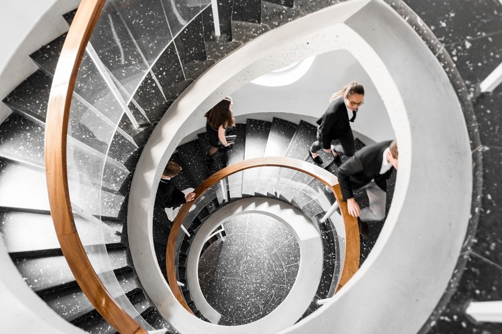Bird's eye view of a black spiral staircase. Students walk up the stairs. Link: Career prospects