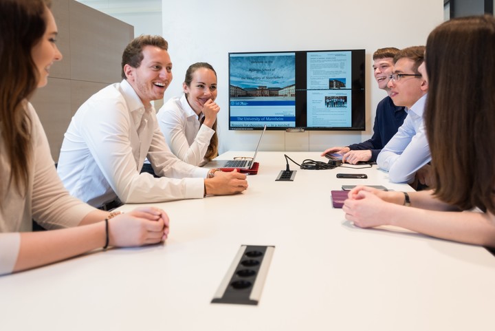 People in business attire sitting around a table