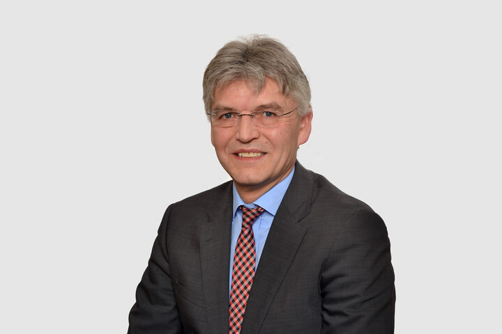 Prof. Spengel hat kurze graue Haare und trägt einen Anzug mit Krawatte.