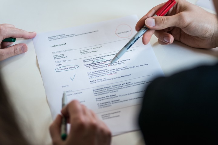 Hands with pens on document