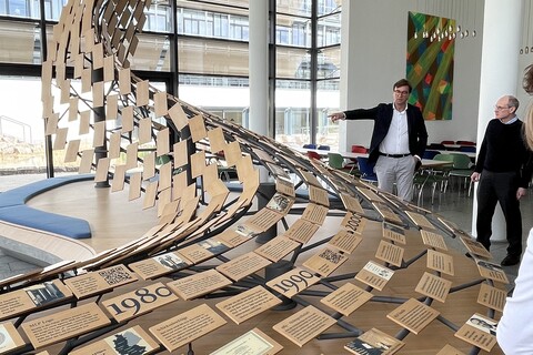 Installation of small wooden signs and people reading the signs